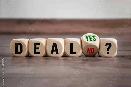 Cubes dice with deal yes or no on wooden background