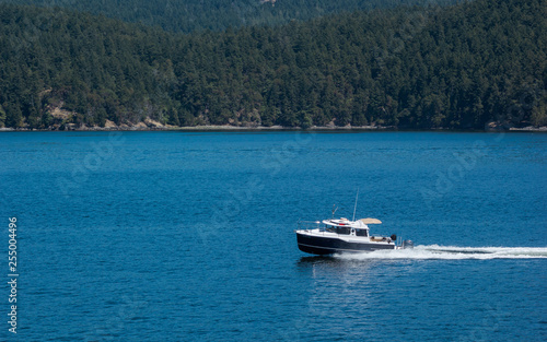 small power boat on blue ocean sunny day © Nicholas