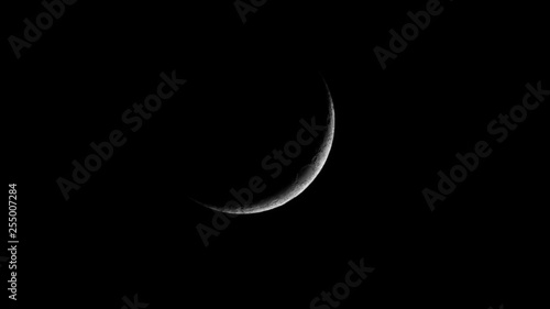 First quarter moon, with craters and surface details visible.