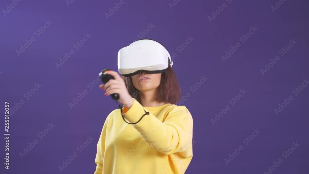 Virtual reality game. Girl with pleasure uses head-mounted display. Virtual reality game. Girl with pleasure uses head-mounted display.