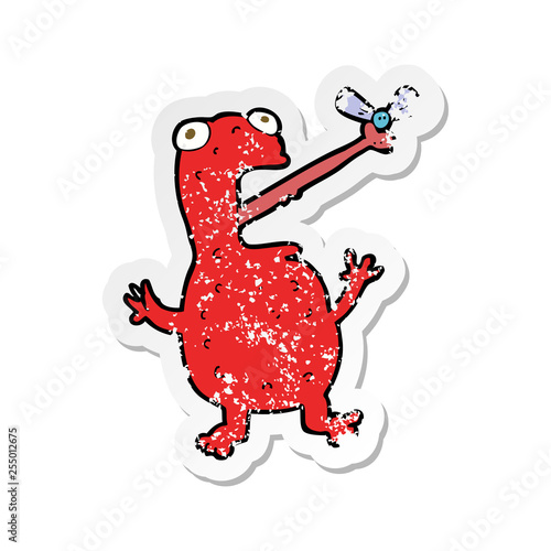 retro distressed sticker of a cartoon poisonous frog catching fly