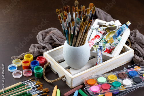 Paint brushes and paints for drawing.