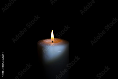 burning candle in the dark, isolate