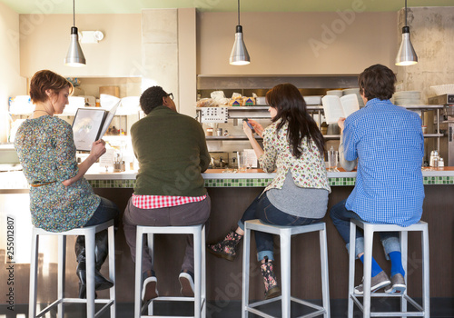 Antisocial group of people strangers waiting for service and ignoring each other in cafe diner photo