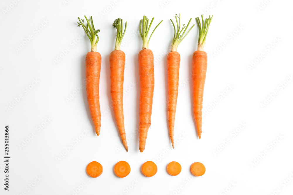 Flat lay composition with ripe fresh carrots on white background - obrazy, fototapety, plakaty 