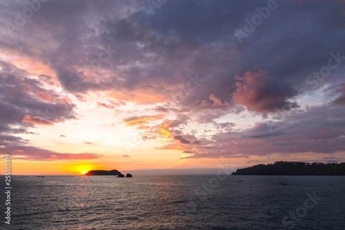 Dramatic Sunset Sky and Stormy Clouds over Pacific Ocean Coastline on Manuel Antonio National Park Beach in Coast Rica