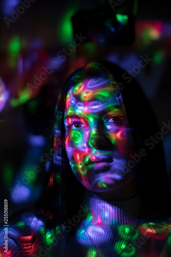 woman in black dress on street of city at night