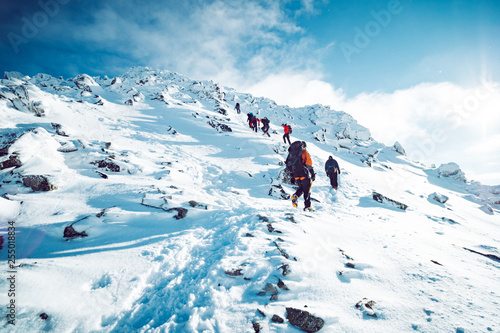A group of climbers ascending a mountain in winter Fototapet