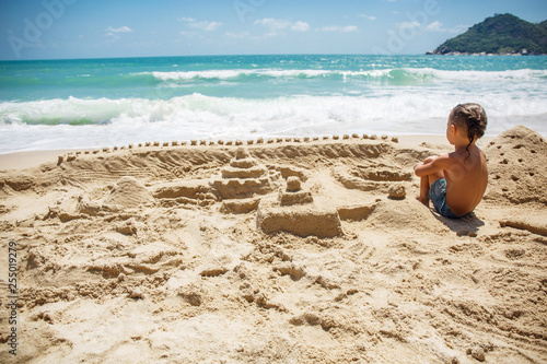 little boy built a sand castle 