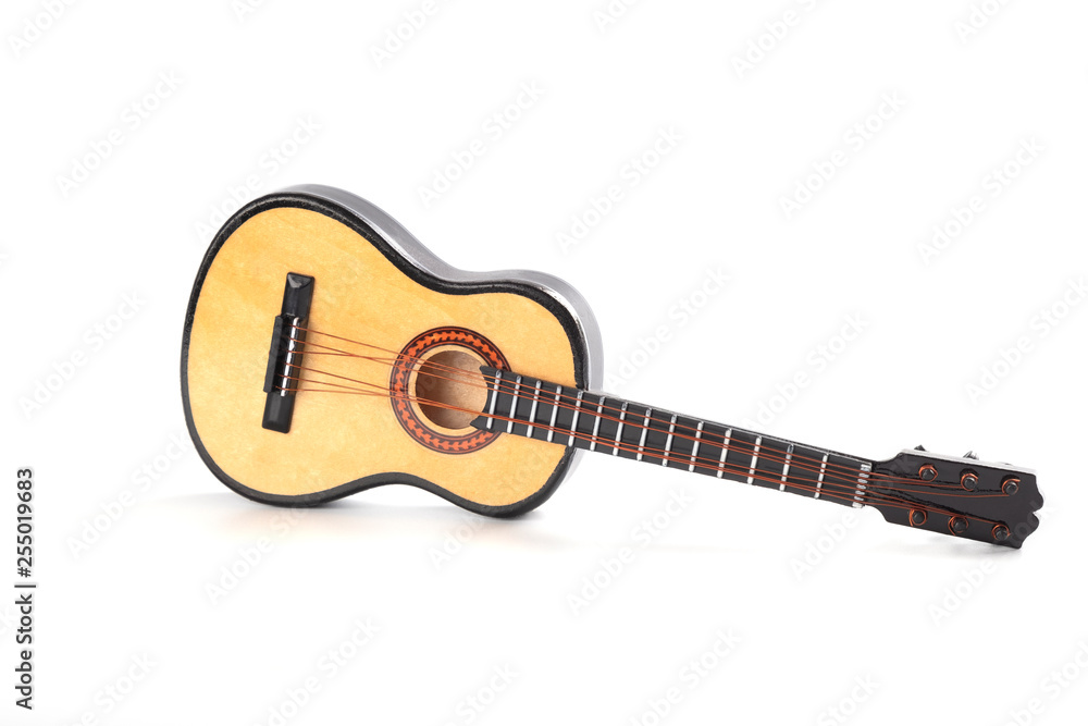 Fototapeta premium Wooden acoustic guitar - miniature. Realistic guitar toy