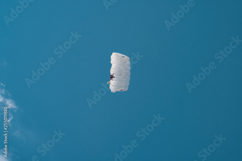 White parachute in blue sky photo