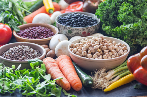 A table with bowls of beans and mixed vegetables