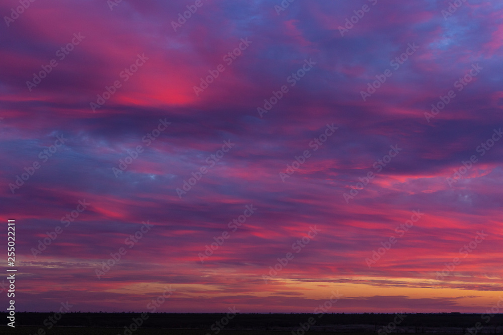 Landscape with bloody sunset. The terrain in southern Europe. Tragic gloomy sky. Purple-magenta clouds.