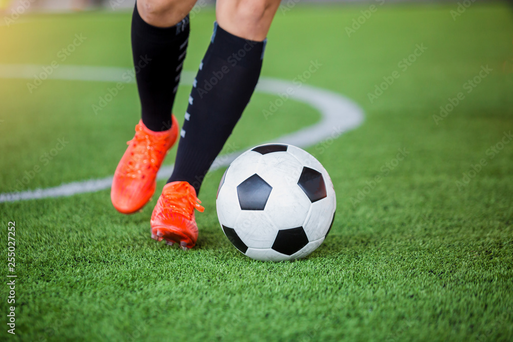 Soccer player speed run to control and shoot ball to goal on artificial turf Soccer player speed run to control and shoot ball to goal on artificial turf