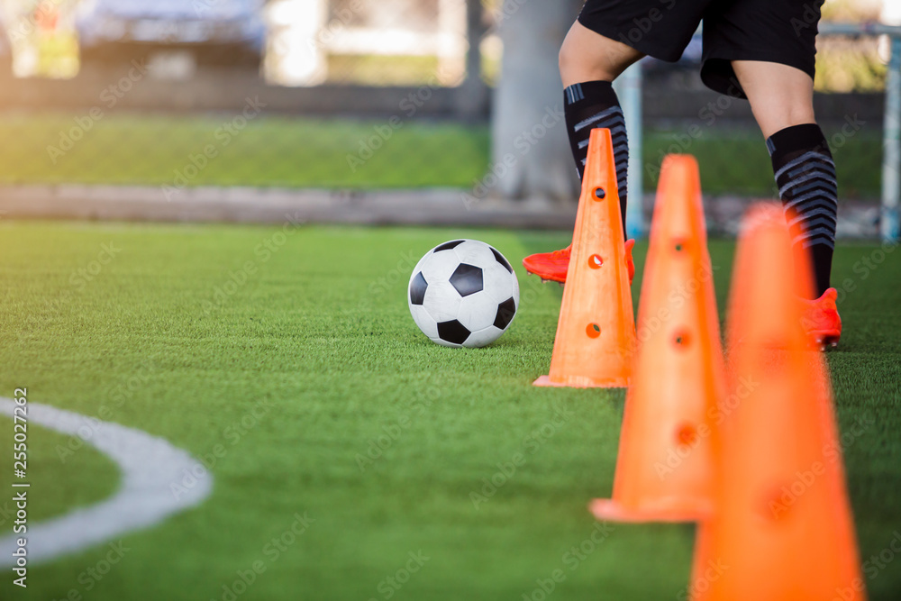 Naklejka premium soccer player jogging with trap and control football