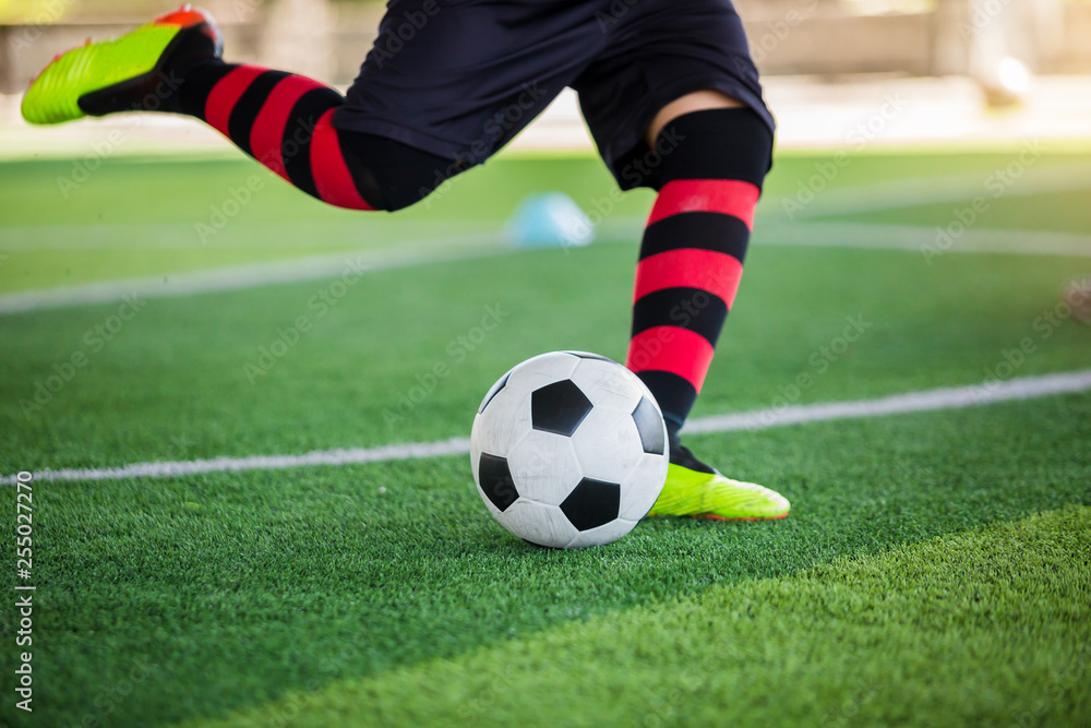 Soccer player speed run to control and shoot ball to goal on artificial turf Soccer player speed run to control and shoot ball to goal on artificial turf