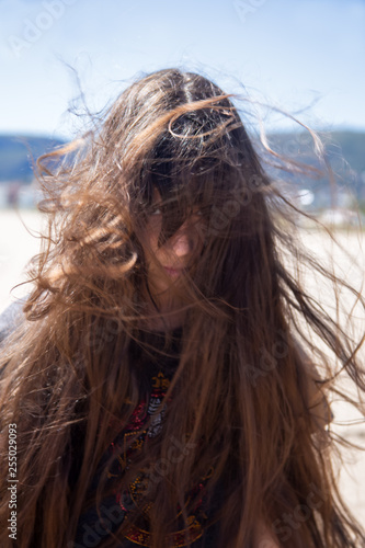 Принти на полотні Brunette girl with long hair flying in the wind