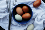 Rustic moody image of brown fresh farm eggs, flat lay of ingredient prep for cooking.