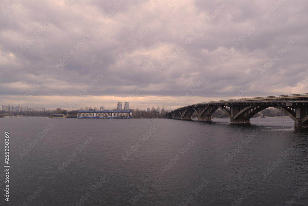 View of the river and bridge away in cloudy weather in nature.