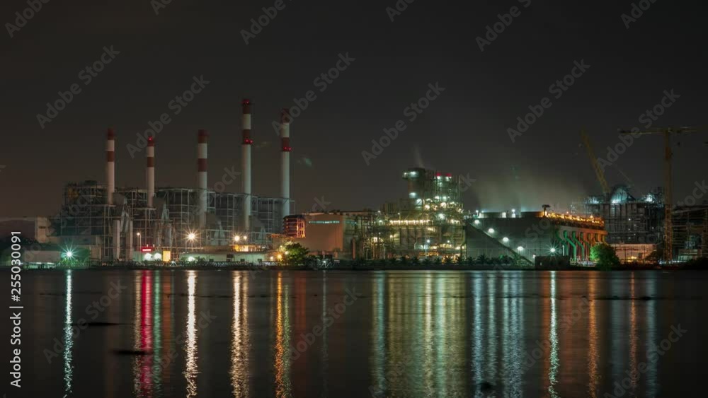 Time-lapse The petrochemical plant is located by the river. at night. Time-lapse The petrochemical plant is located by the river. at night.