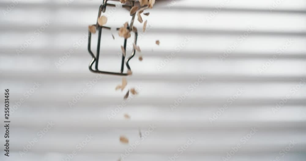 Golden oat blend falling on breakfast table in slow motion Golden oat blend falling on breakfast table in slow motion