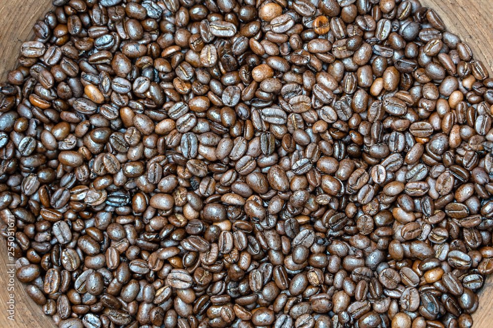 Roasted coffee beans in a clay pot in the local market, Bali, Indonesia. Close up Roasted coffee beans in a clay pot in the local market, Bali, Indonesia. Close up