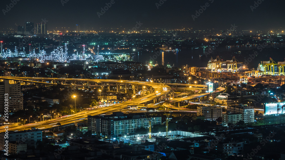 Bangkok city, Thailand, showing traffic on motor way, oil refinery and shipping port at night