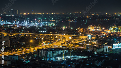 Bangkok city, Thailand, showing traffic on motor way, oil refinery and shipping port at night