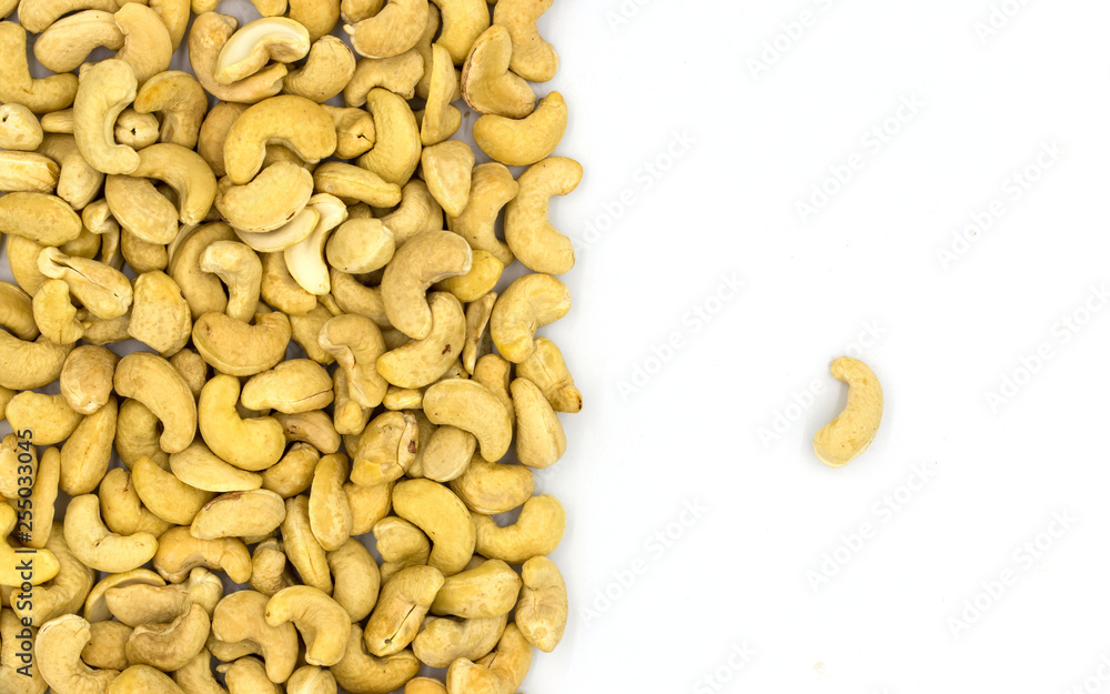 Cashew nuts on white background, top view concept photo. Scattered nut on table. Organic food rustic banner template Cashew nuts on white background, top view concept photo. Scattered nut on table. Organic food rustic banner template