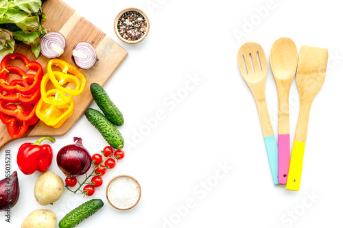 cooking with raw vegetables on white background top view
