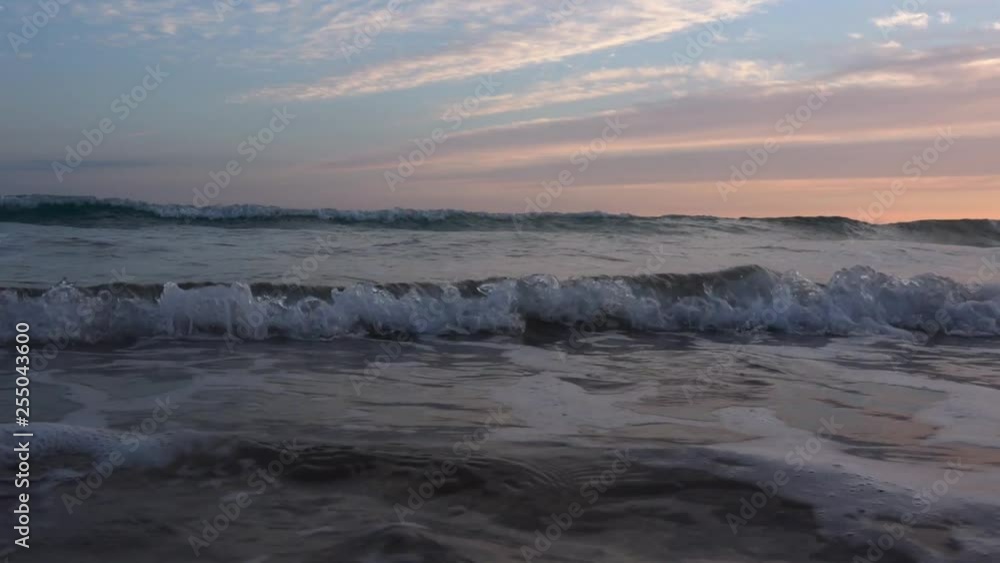 Slow motion waves at the shoreline of Tarifa beach at sunset, Andalucia, Spain. Very relaxing waves lapping at the beautiful beach of Tarifa. Slow motion waves at the shoreline of Tarifa beach at sunset, Andalucia, Spain. Very relaxing waves lapping at the beautiful beach of Tarifa.