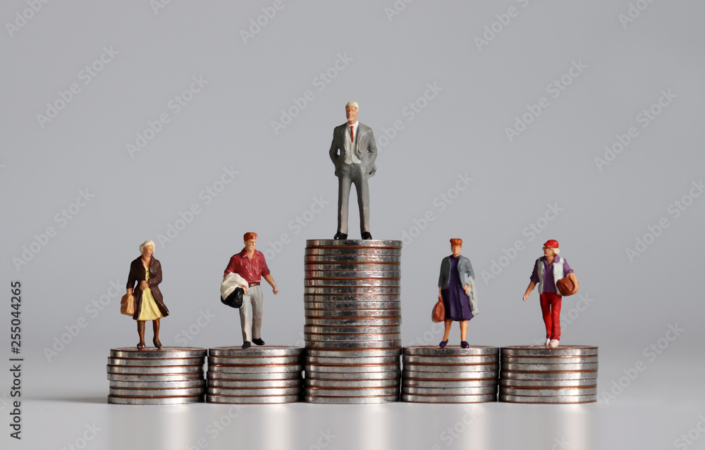 Miniature people with stack of coins. A concept of income inequality. - obrazy, fototapety, plakaty 