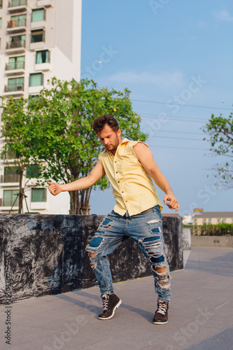 Young man dancing breakdance on the street. photo