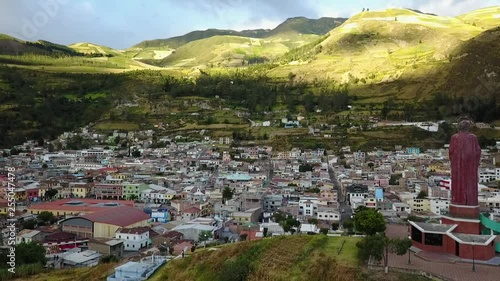 Slow aerial push-in past the Mirador de San Pedro and over the mountain town Alausí, Ecuador