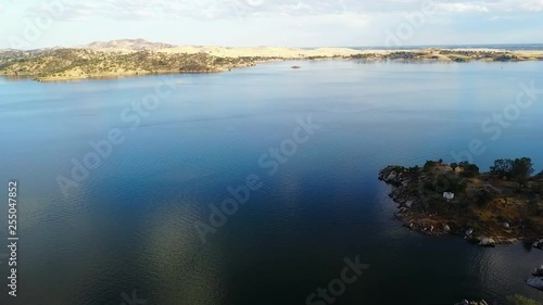 Drone view over Millerton Lake, California with camping ground in the foreground and yellow hills in the distance. photo