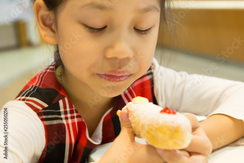 Pretty little girl eating Dessert sweet donut