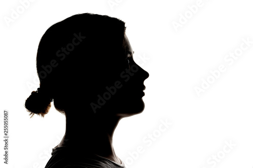 Dark silhouette profile of young girl on a white background, the concept of anonymity