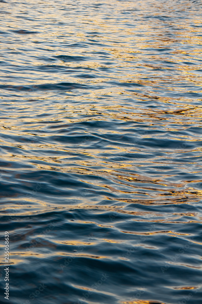 Sea wave surface that reflected with blue, yellow sky color in the evening in Koh Mak Island at Trat, Thailand. Sea wave surface that reflected with blue, yellow sky color in the evening in Koh Mak Island at Trat, Thailand.