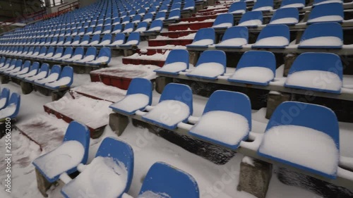 Stadium empty seating chairs covered with snow in winter photo