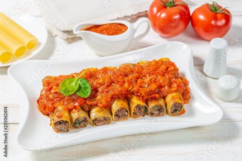 Cannelloni with ground beef baked in tomato sauce