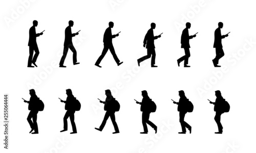 スマホを見ながら歩く人 A man walking while looking at a smartphone