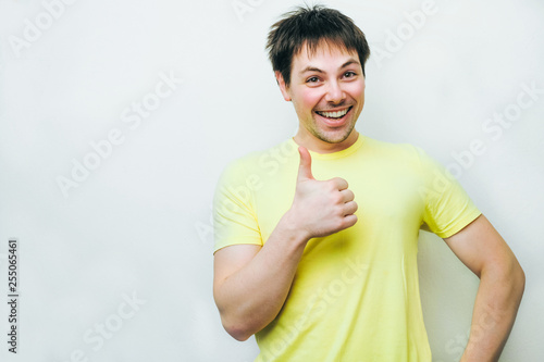 Excited overjoyed man feel happy looking at camera, euphoric winner Shows class sign celebrating win victory success triumph isolated at white grey studio background