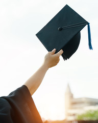 Close up selective focus of the university graduate celebrates graduation in commencement day after receiving degree certificate happily and enjoyably