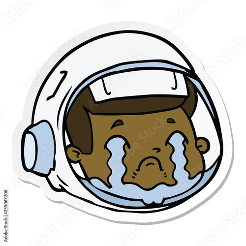 sticker of a cartoon astronaut face crying