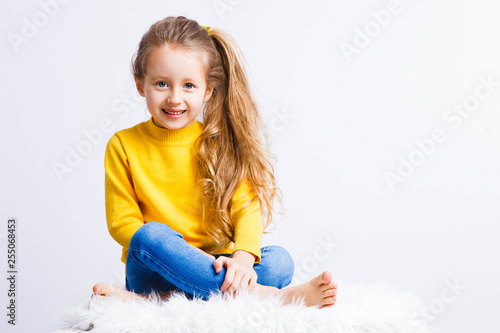 Cute girl 4-5 year old posing in studio. Original, square photo with space for text.