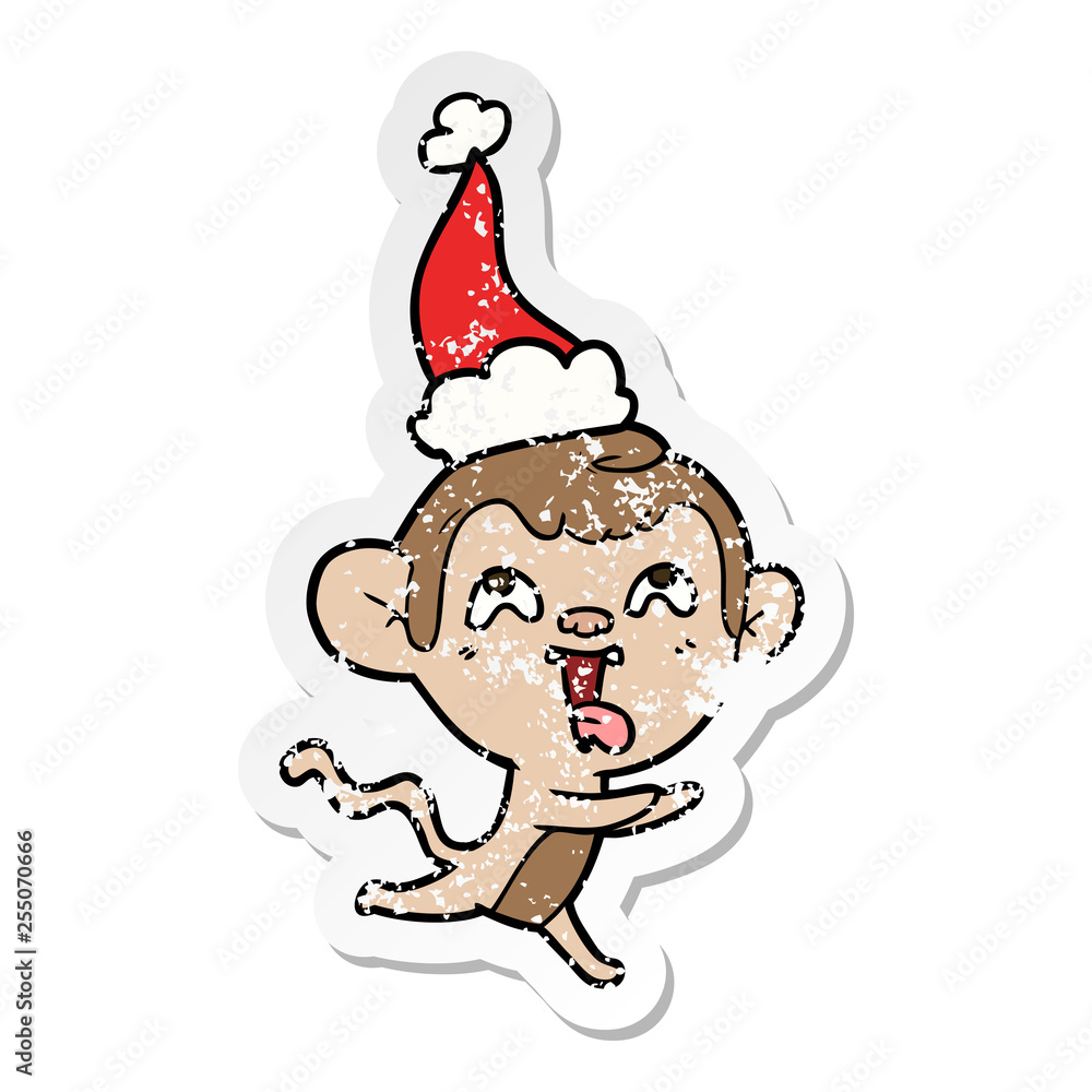 crazy distressed sticker cartoon of a monkey running wearing santa hat crazy distressed sticker cartoon of a monkey running wearing santa hat