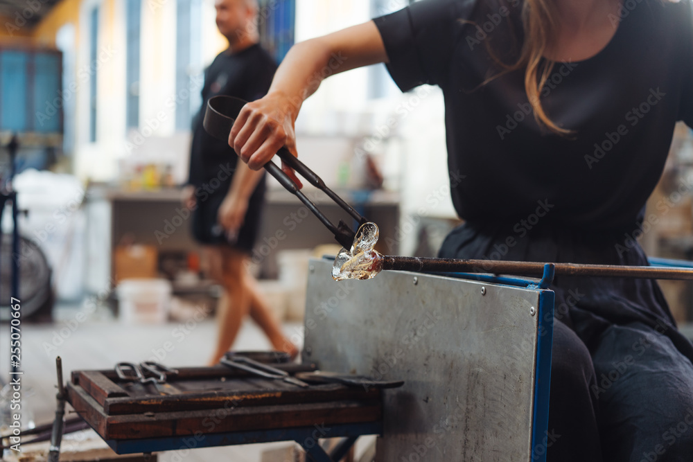 A glassblower student tries to make a flower out of glass A glassblower student tries to make a flower out of glass