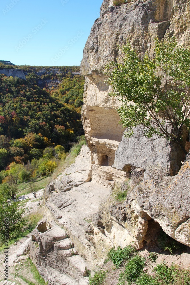 View on the cavetown Chufut-Kale in the autumn near Bakhchisarai city on the Crimean Peninsula. It'is a medieval city-fortress in the Crimean Mountains that now lies in ruins.