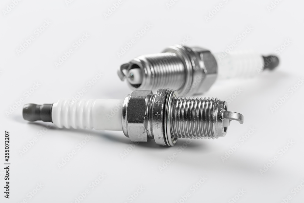 spark plugs on white background, shallow depth of field spark plugs on white background, shallow depth of field