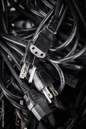 Black power cables cords in a pile (US 3-Prong For PC server many electric home office industrial appliance) © KSOLstudios